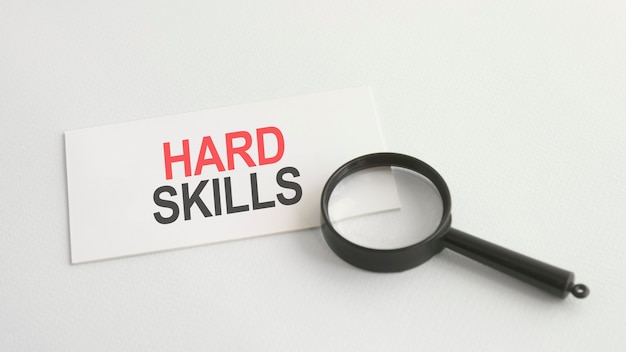 Hard skills word on white paper card and magnifying lens