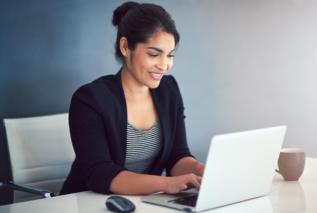 Hard work leads to success Cropped shot of an attractive young businesswoman working on a laptop in her office