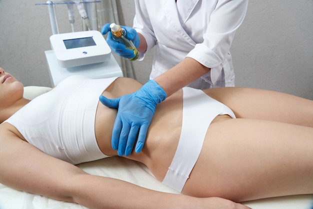 Hardware cosmetology young woman getting beauty treatment in spa salon