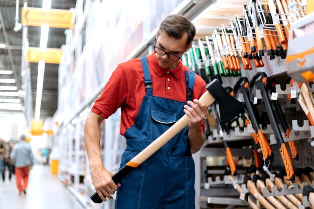 Hardware store clerk looking at the markings on the axe