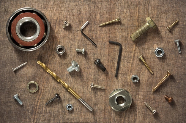 Hardware tools and screws at wood