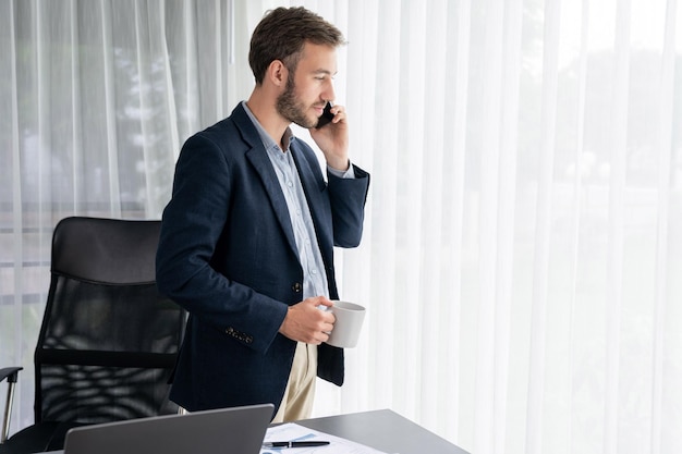 Photo hardworking businessman stand in modern office talking on phone entity