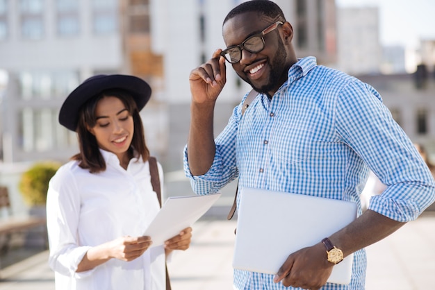 Hardworking diligent brilliant guy regularly seeing his business partner for discussing topics concerning their joint project