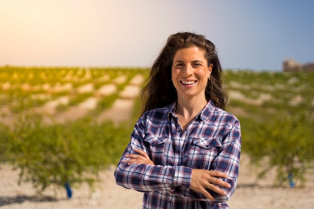 hardworking farmer woman in a plaid shirt and long brunette hair