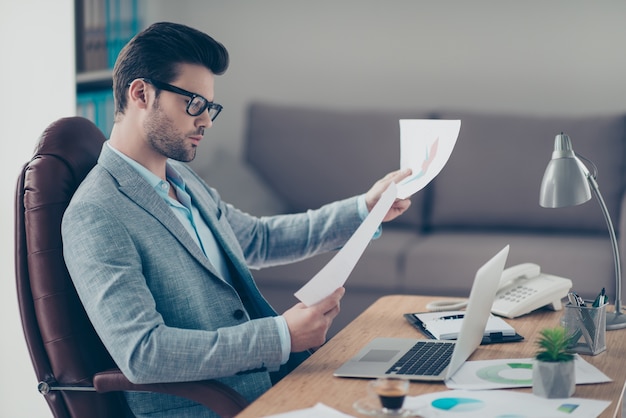 Hardworking man in suit working at desk