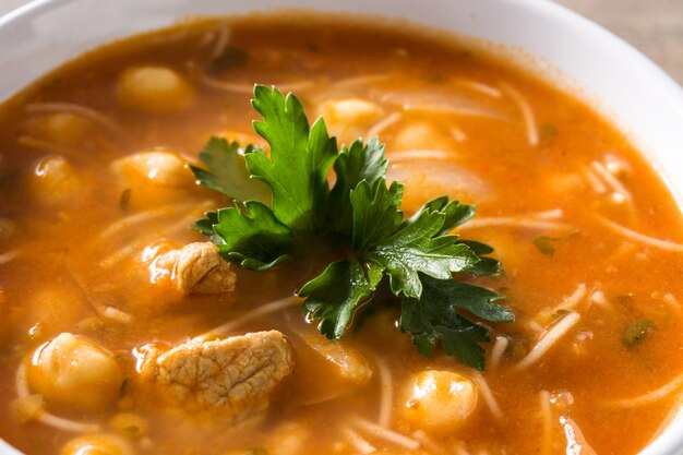 Harira soup in bowl on wooden table typical moroccan food