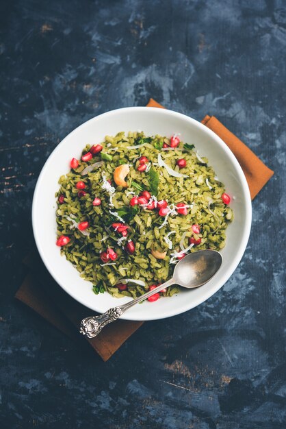 Hariyali Poha, Green Masala Pohe or flattened rice served in a bowl, selective focus