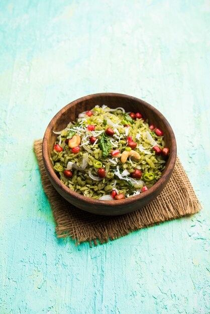 Hariyali Poha, Green Masala Pohe or flattened rice served in a bowl, selective focus