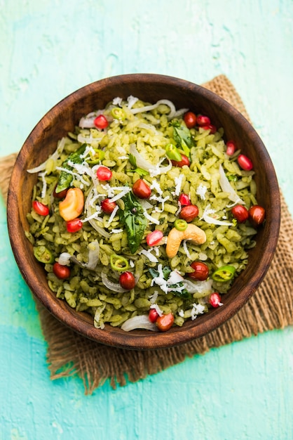 Hariyali Poha, Green Masala Pohe or flattened rice served in a bowl, selective focus