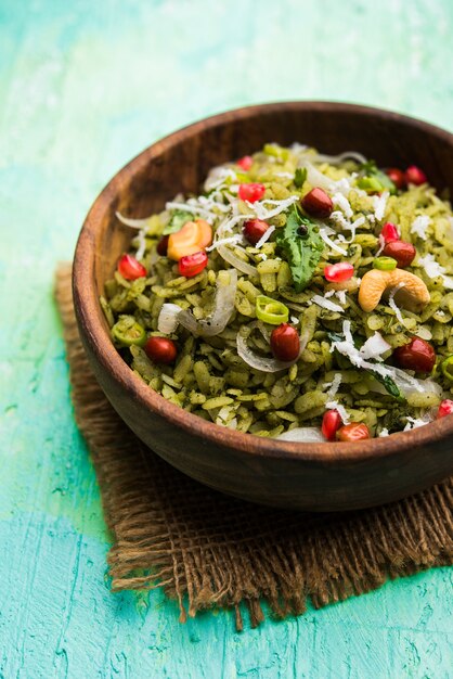 Hariyali Poha, Green Masala Pohe or flattened rice served in a bowl, selective focus