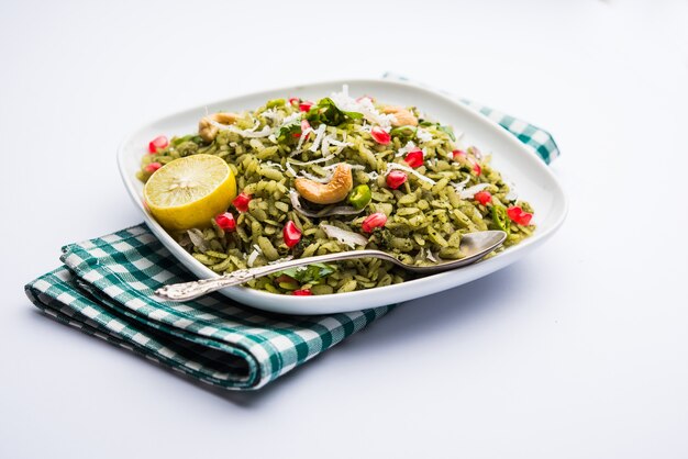 Hariyali Poha, Green Masala Pohe or flattened rice served in a bowl, selective focus