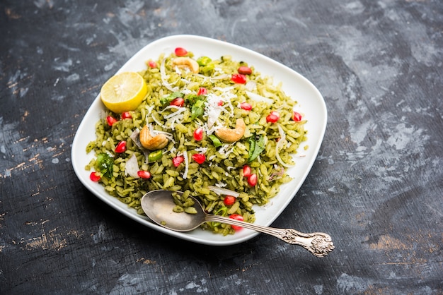 Hariyali Poha, Green Masala Pohe or flattened rice served in a bowl, selective focus