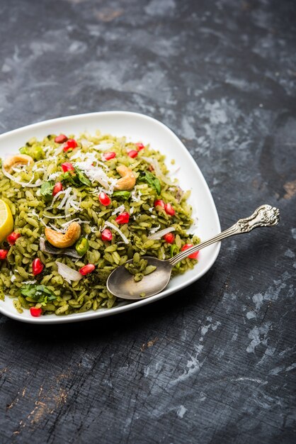 Hariyali Poha, Green Masala Pohe or flattened rice served in a bowl, selective focus