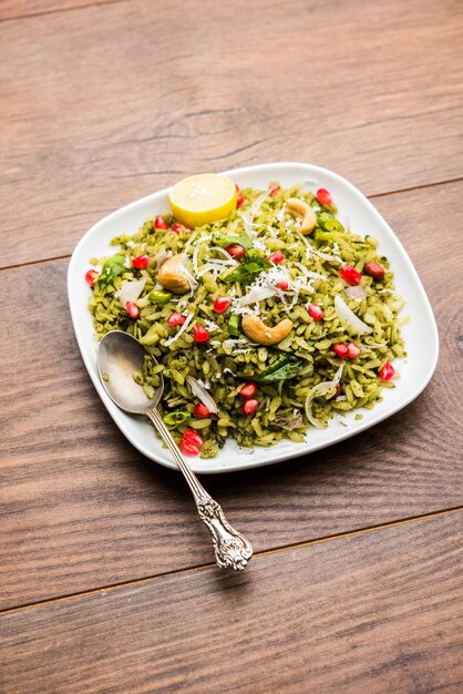 Hariyali Poha, Green Masala Pohe or flattened rice served in a bowl, selective focus