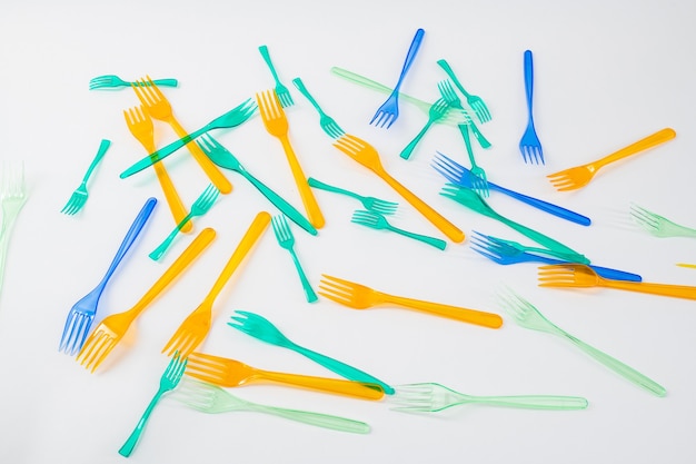 Harming our environment. Clear plastic forks made of transparent cheap plastic being thrown and causing global warming