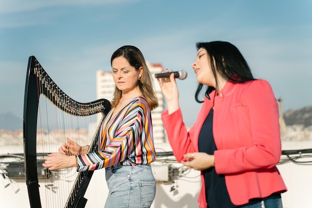 Harp and voice duo performing on the roof of the building