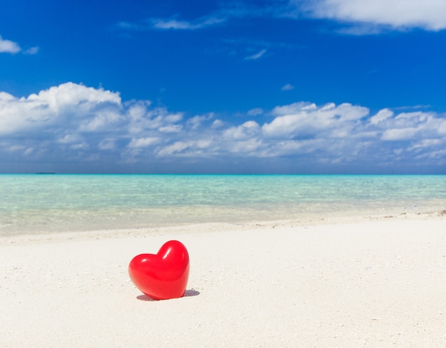 hart speelgoed in het strand, liefde, zomervakantie en huwelijksreis concept.