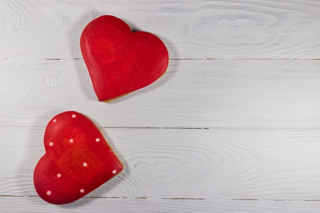 Hartvormige koekjes voor Valentijnsdag op witte houten tafel. Bovenaanzicht, kopieer ruimte