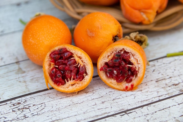 Harvest of orange fruits of wild passion fruit on wood