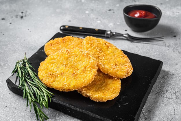 Hash brown potato with ketchup hashbrown on white table Gray background Top view