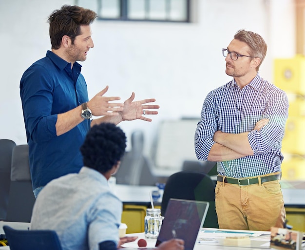 Hashing out new ideas Shot of a group of coworkers talking together in an office