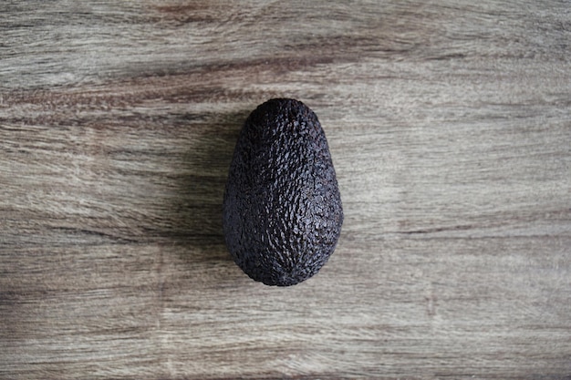 Hass avocado fruit on rustic wooden table