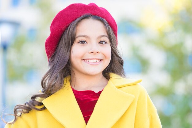 Hat accessory french fashion detail. Kid girl bright hat beret. Autumn hat fashion accessory. French trend fall season. Girl walk defocused background. Charming little french style fashionable girl.