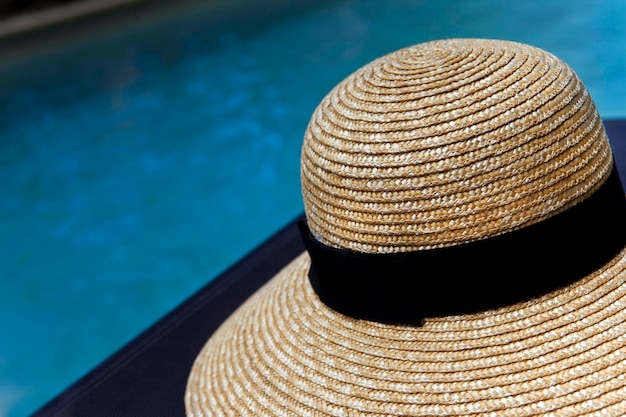 Hat beside a swimming pool