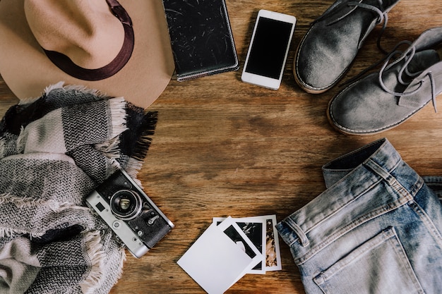 Hat camera sweater jeans phone notebook