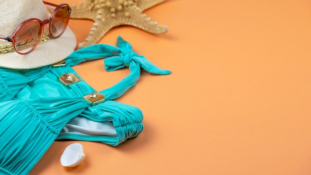 Hat, sunglasses, beach swimsuit and seashells.