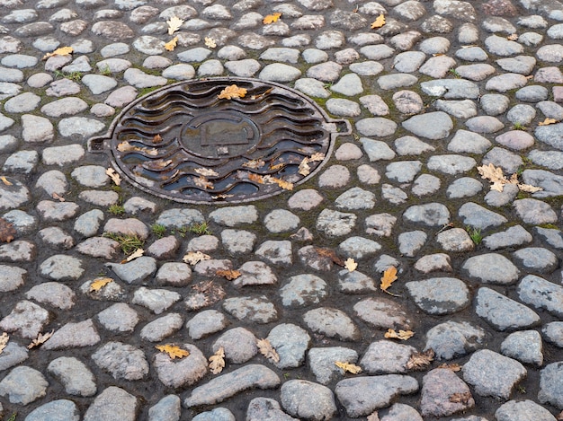 Hatch on the cobblestone street in autumn.