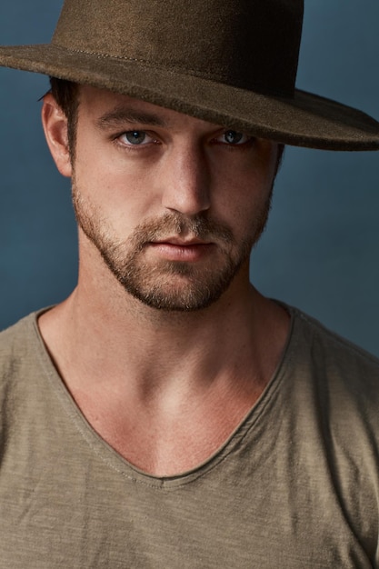 Hats are a great accessory to elevate your style Studio portrait of a handsome young man wearing a hat against a dark background