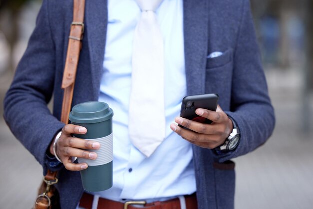 Have the courage to follow your own dreams. Shot of a unrecognizable business man using his cellphone outside.