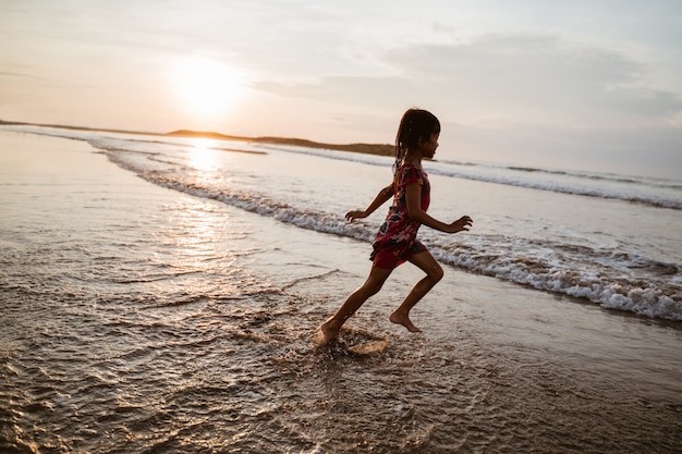 Photo have fun little asian girl running