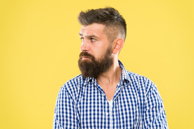 Have some doubts. Hipster bearded face not sure in something. Thoughtful bearded man on yellow background close up. Thoughtful expression. Need to think. Thoughtful man hesitating making decision.