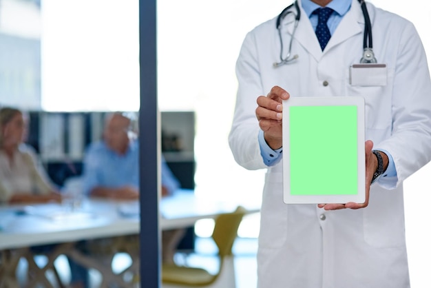 have you read about the latest medical development cropped shot of a doctor holding a digital tablet with a chroma key screen