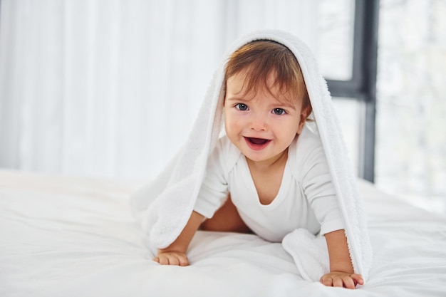 Having fun Cute little baby is indoors in the domestic room