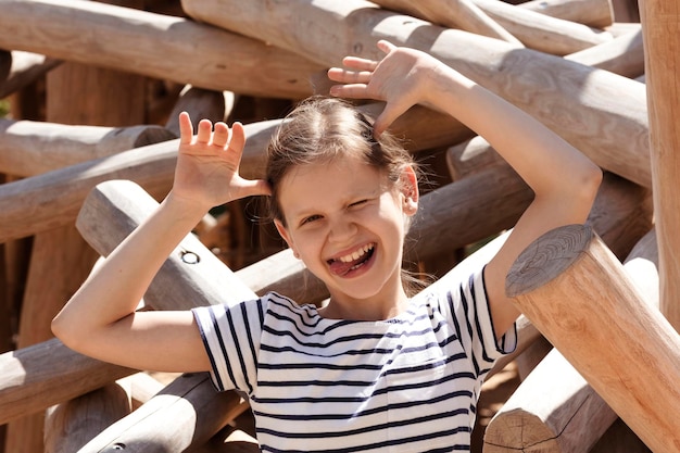 Having fun on Holiday on Children Playground Pretty Cute Kid Little Girl Portrait with Tongue out