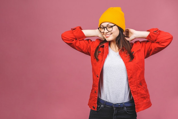 Having fun! Portrait of happy young hipster woman in yellow hat and red shirt