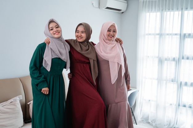 Having fun while spend time three muslim women standing in bed