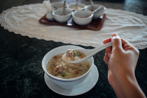 Having homemade pork congee as breakfast.