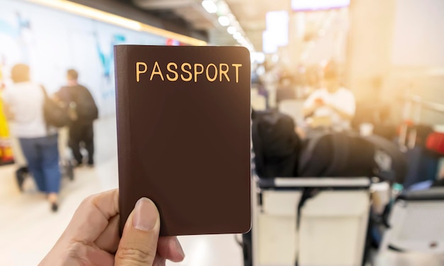 Photo having a passport on hand when traveling seats awaiting the trip having a passport and going abroad