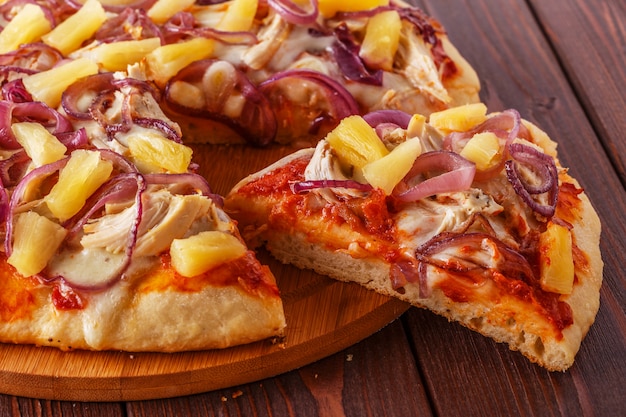 Hawaiian pizza on a dark