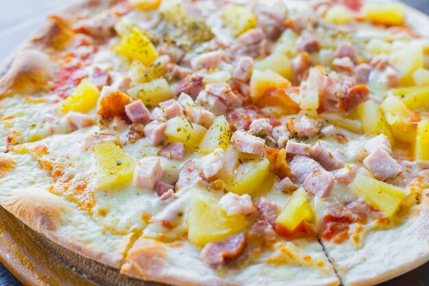 Hawaiian pizza is a Italian food which it made with tomato sauce, chopped pineapple, ham and cheese.