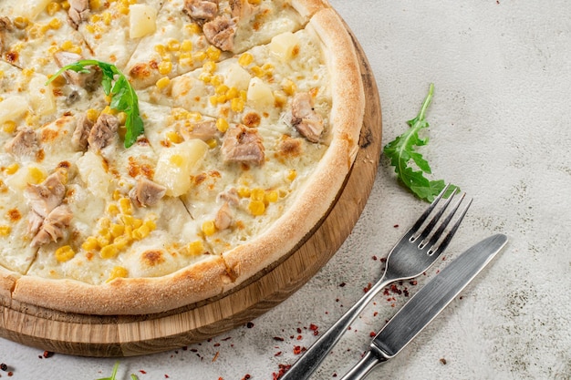 Hawaiian pizza with chicken meat pineapple and corn