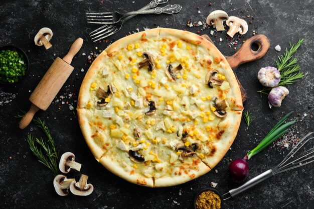 Hawaiian pizza with chicken pineapple and mushrooms on the table Rustic style Top view