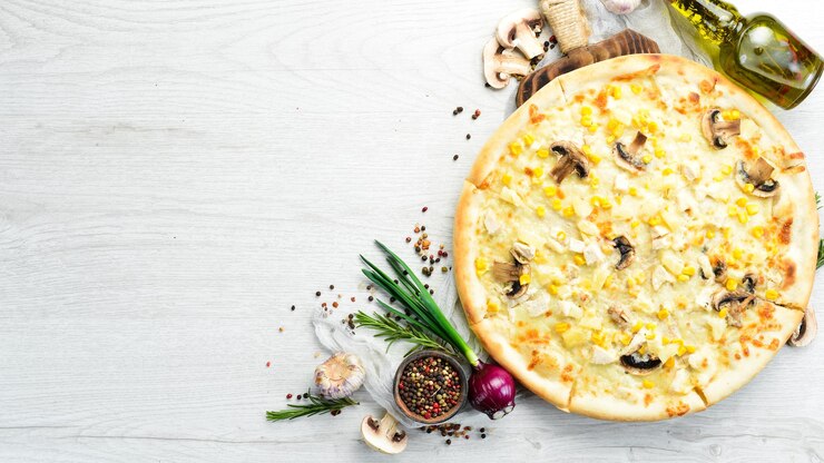 Hawaiian pizza with chicken pineapple and mushrooms on the table Rustic style Top view