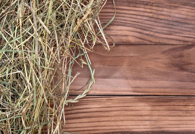 Hay on wooden background Top view Copy space