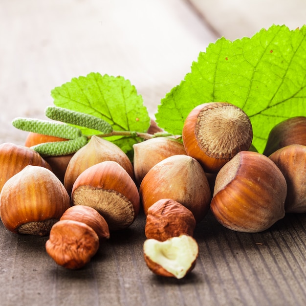 Foto hazelnoten met shell en groen blad op de houten tafel