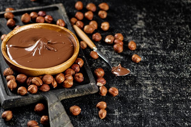 Hazelnut butter on a cutting board with a spoon